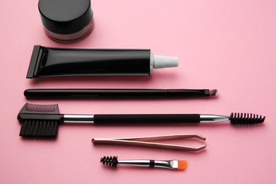 Photo of Eyebrow henna and tools on pink background