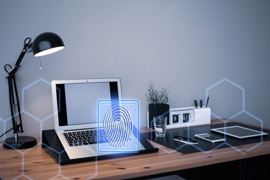 Image of Fingerprint identification. Modern laptop and devices on table indoors