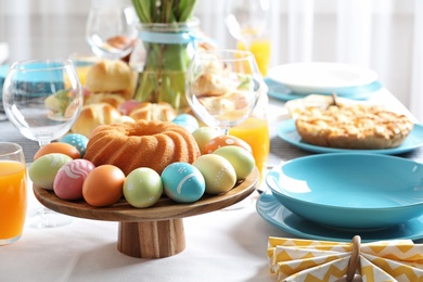 Festive Easter table setting with traditional meal, space for text