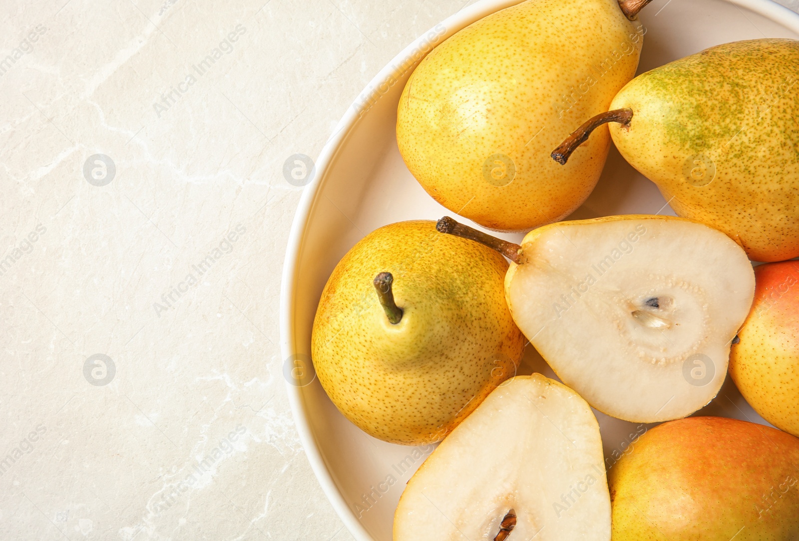 Photo of Plate with pears on grey background, top view. Space for text