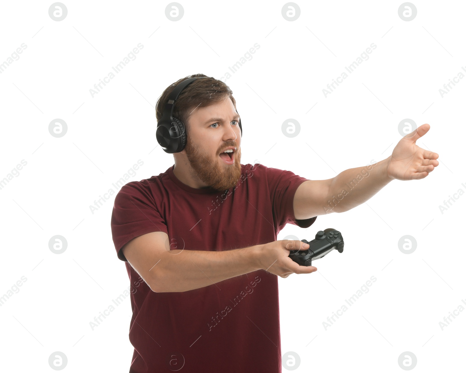 Photo of Emotional man in headphones with game controller on white background