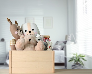 Image of Set of different cute toys on wooden table in children's room. Space for text