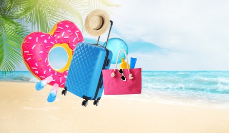 Image of Suitcase and beach accessories flying over sandy beach. Banner design with space for text