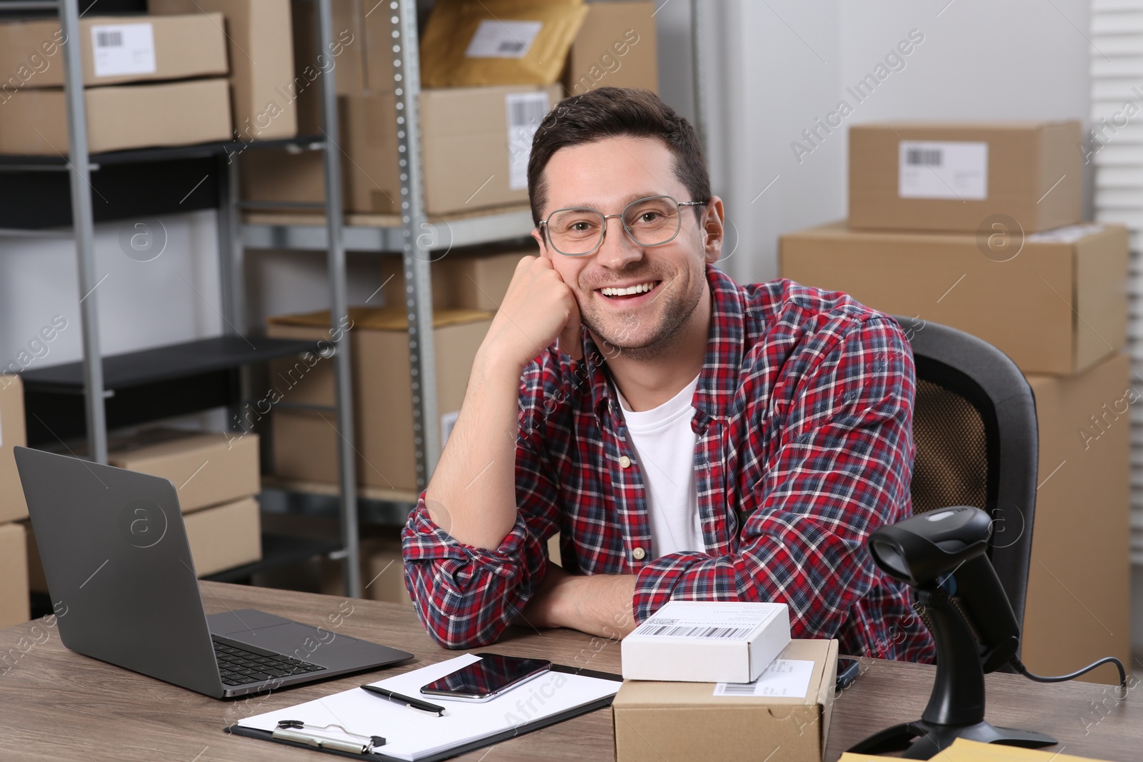 Photo of Seller with laptop at workplace in office. Online store