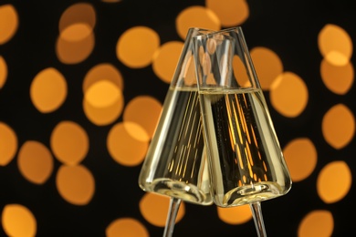 Photo of Glasses of champagne against blurred lights. Space for text