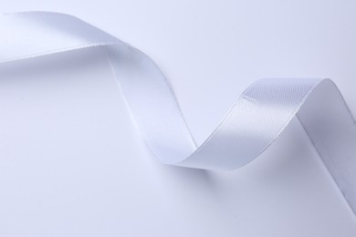 Photo of One beautiful silk ribbon on white background