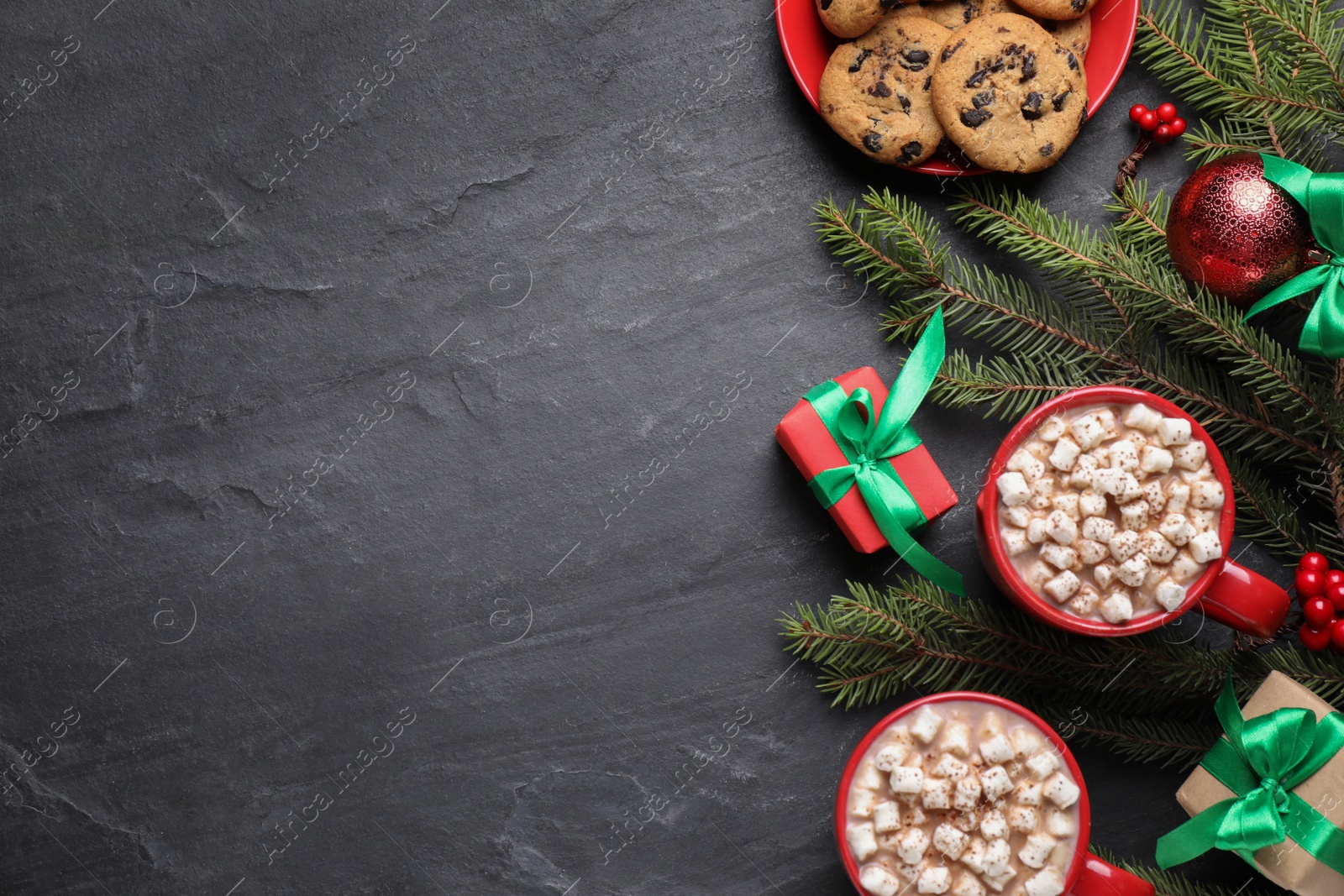 Photo of Flat lay composition with delicious hot cocoa on black table, space for text