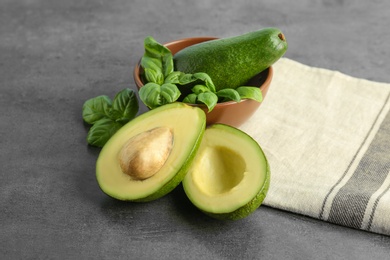 Photo of Composition with ripe avocados and basil on table