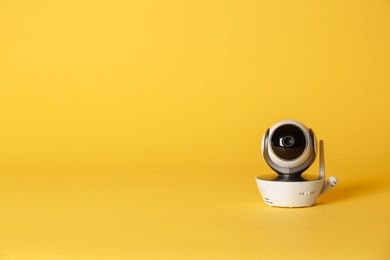 Modern CCTV security camera on color background. Space for text