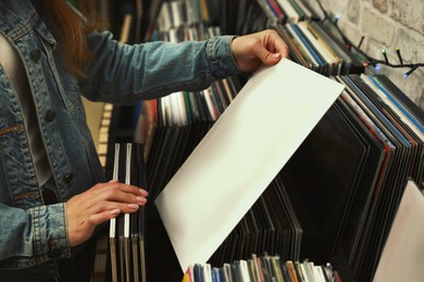 Woman with vinyl record in store, closeup