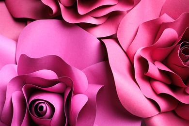Beautiful flowers made of paper as background, top view