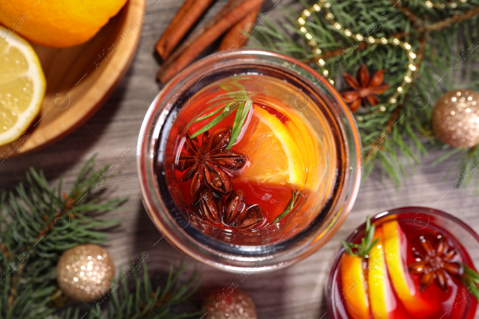 Photo of Aromatic punch drink and Christmas decor on wooden table, flat lay