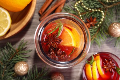 Photo of Aromatic punch drink and Christmas decor on wooden table, flat lay