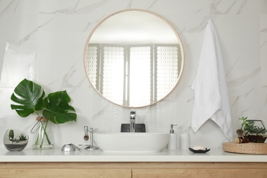 Photo of Stylish bathroom interior with vessel sink and round mirror