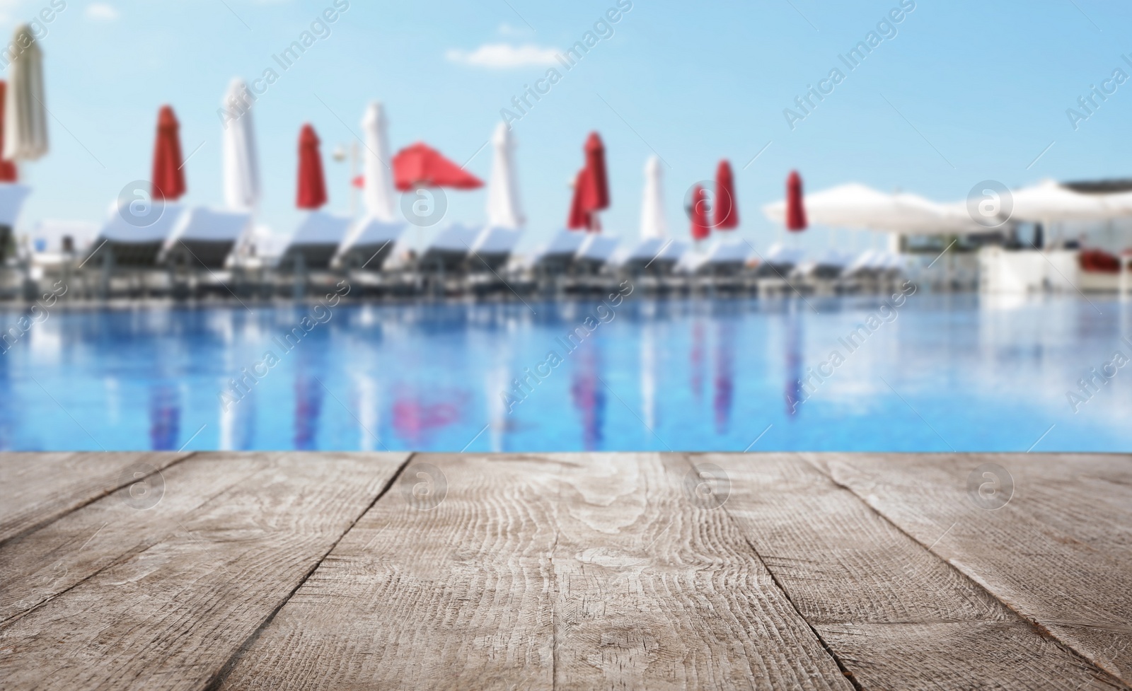 Image of Wooden deck near swimming pool outdoors on sunny day. Space for text