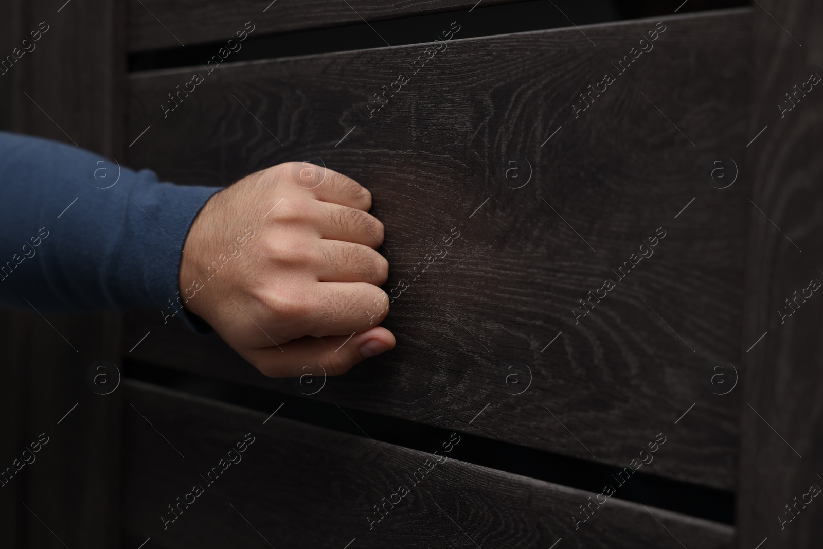 Photo of Collection agent knocking on wooden door, closeup