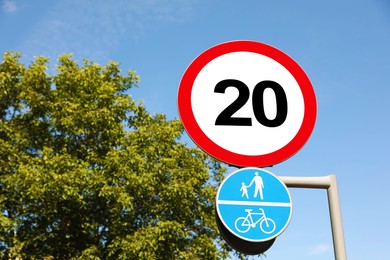 Road signs Maximum speed limit and Shared cycle and pedestrian path outdoors