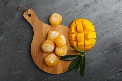 Photo of Delicious mango mochi on grey table, flat lay