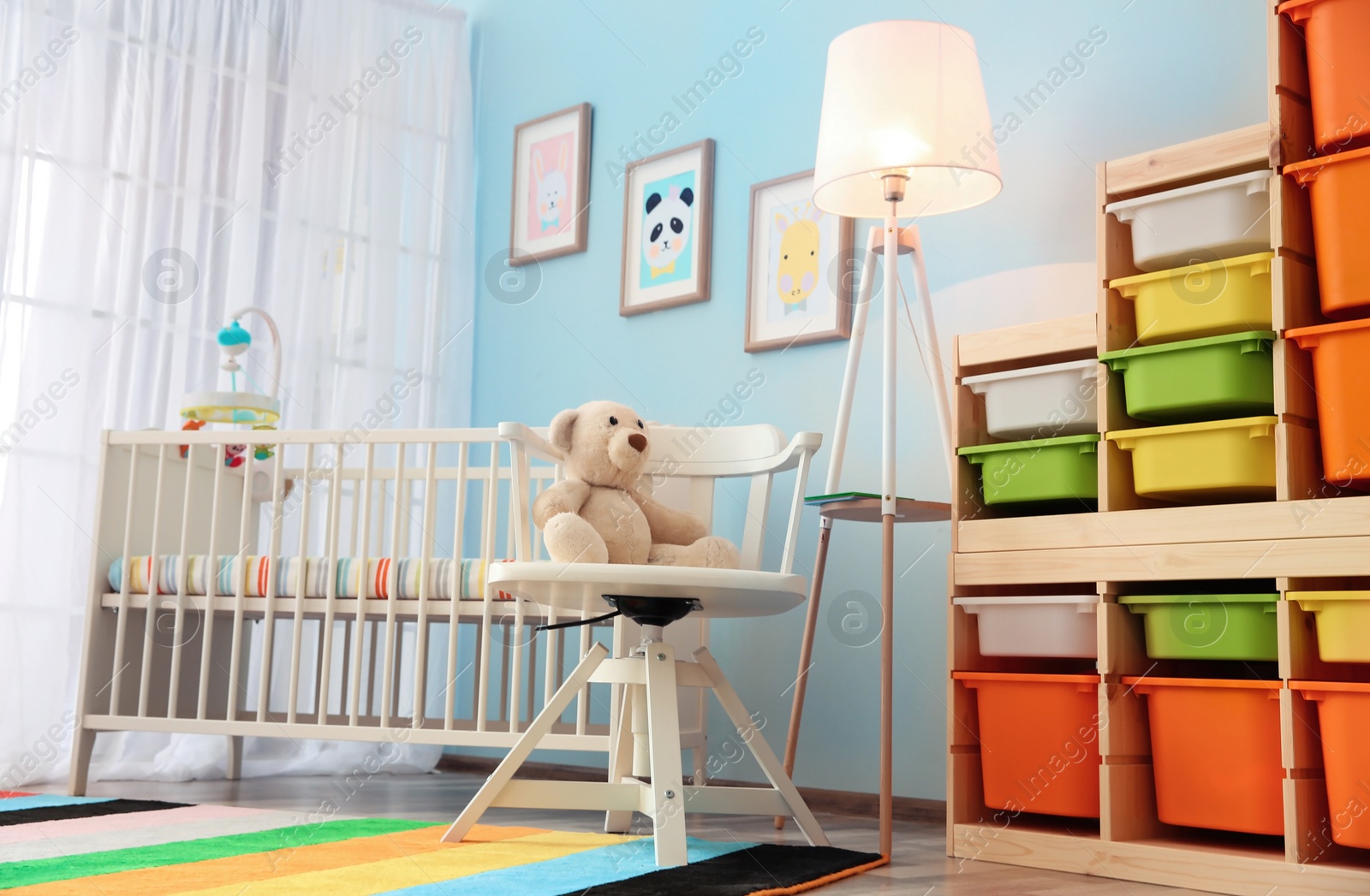 Photo of Modern interior of light cozy baby room with crib