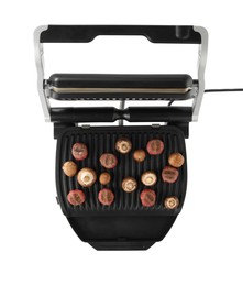 Photo of Electric grill with meat balls and mushrooms isolated on white, top view