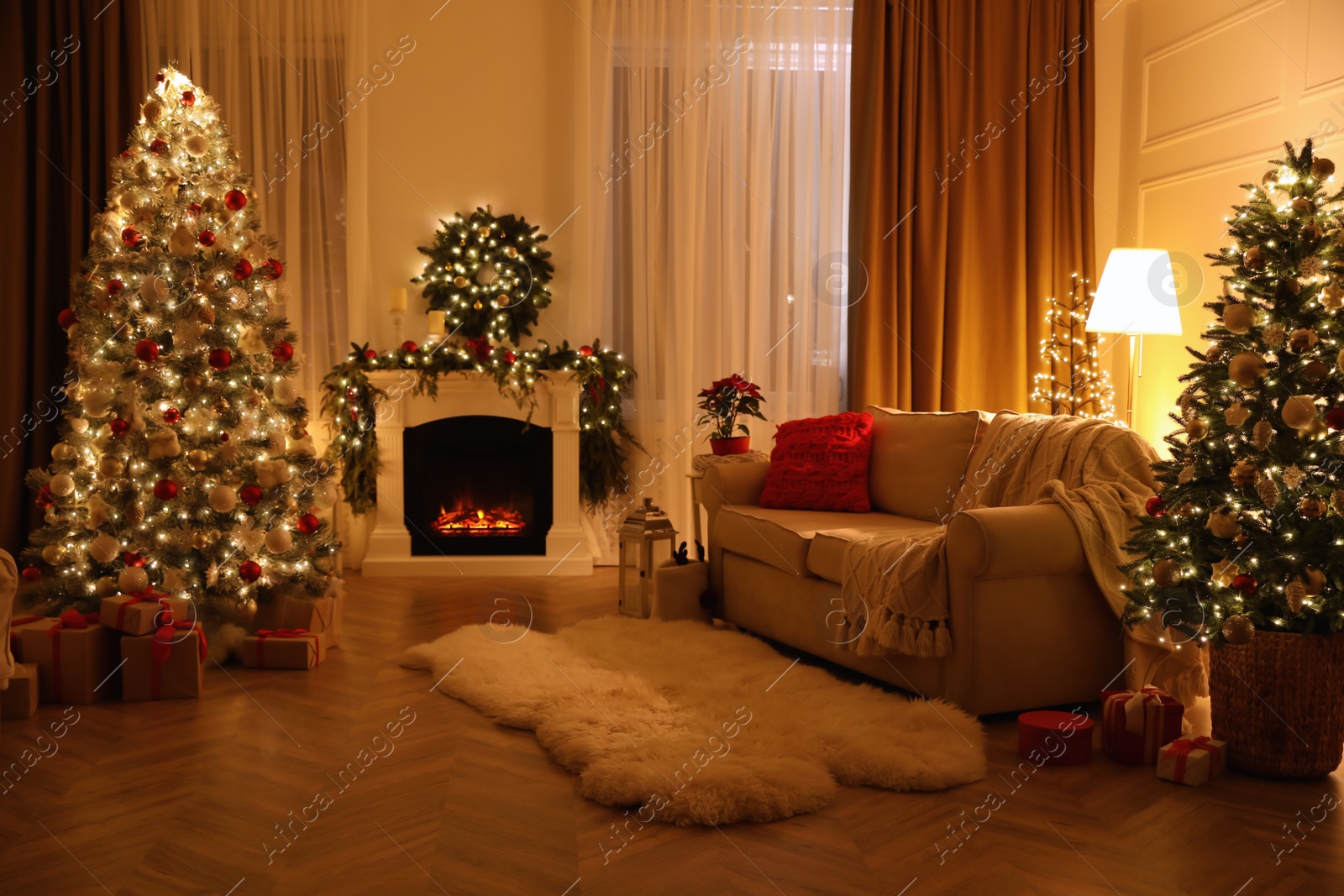 Photo of Festive living room interior with Christmas trees and fireplace