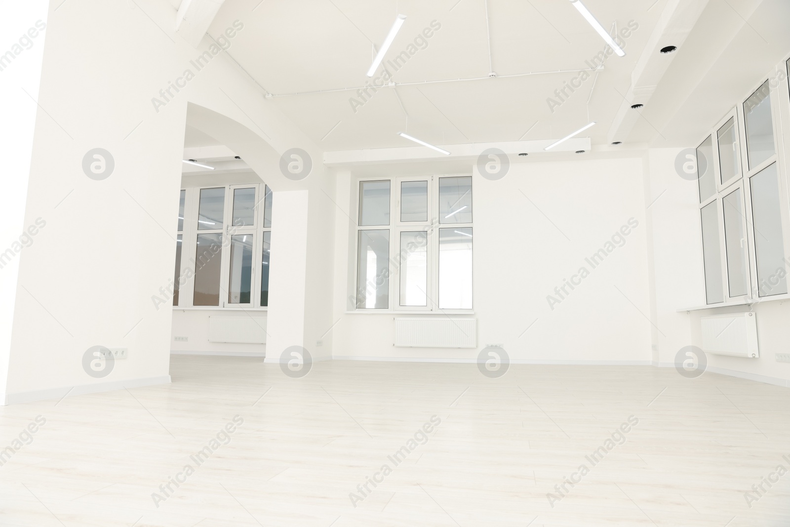 Photo of Modern office room with white walls and windows. Interior design