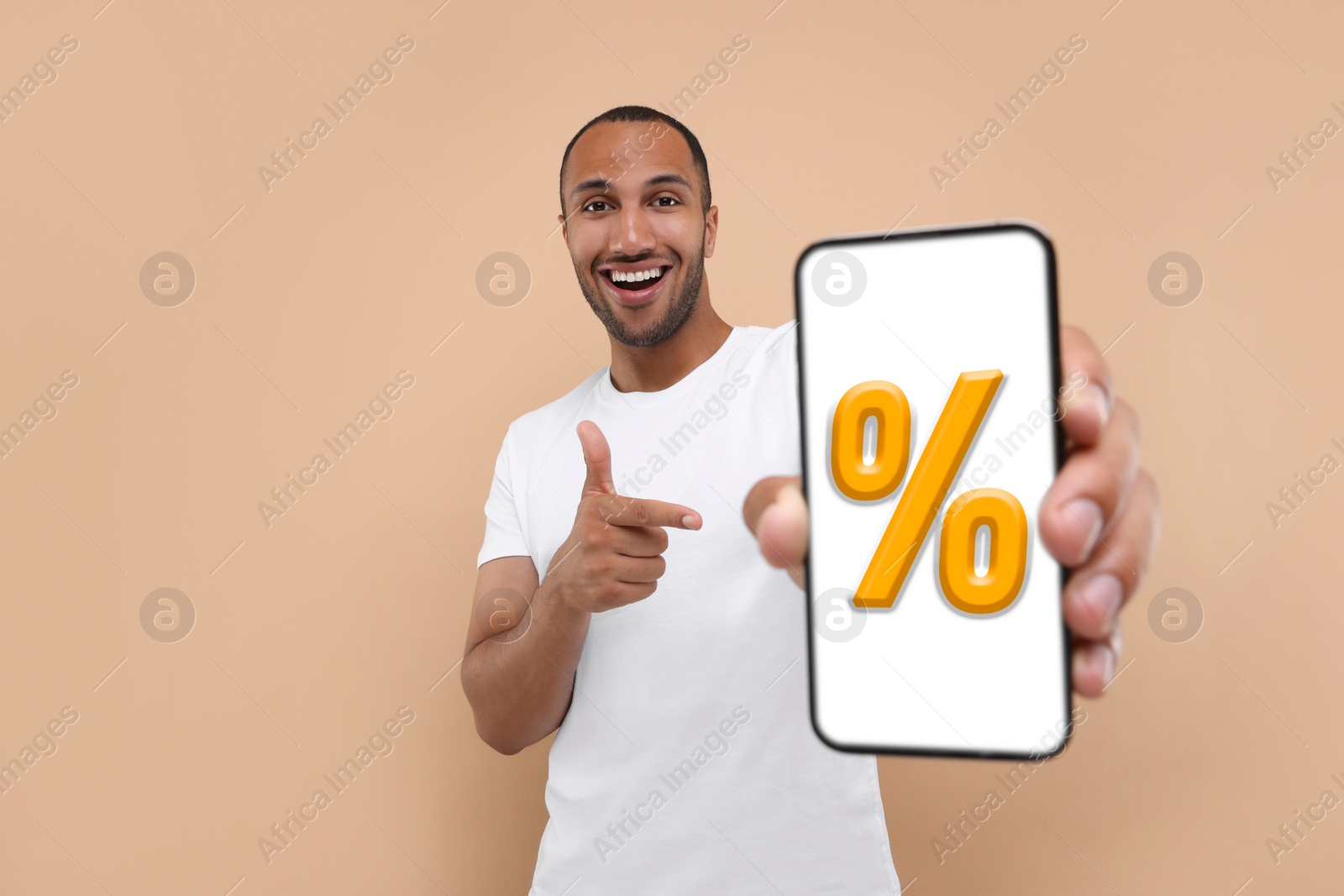 Image of Discount, offer, sale. Man pointing at mobile phone with percent sign on screen, beige background