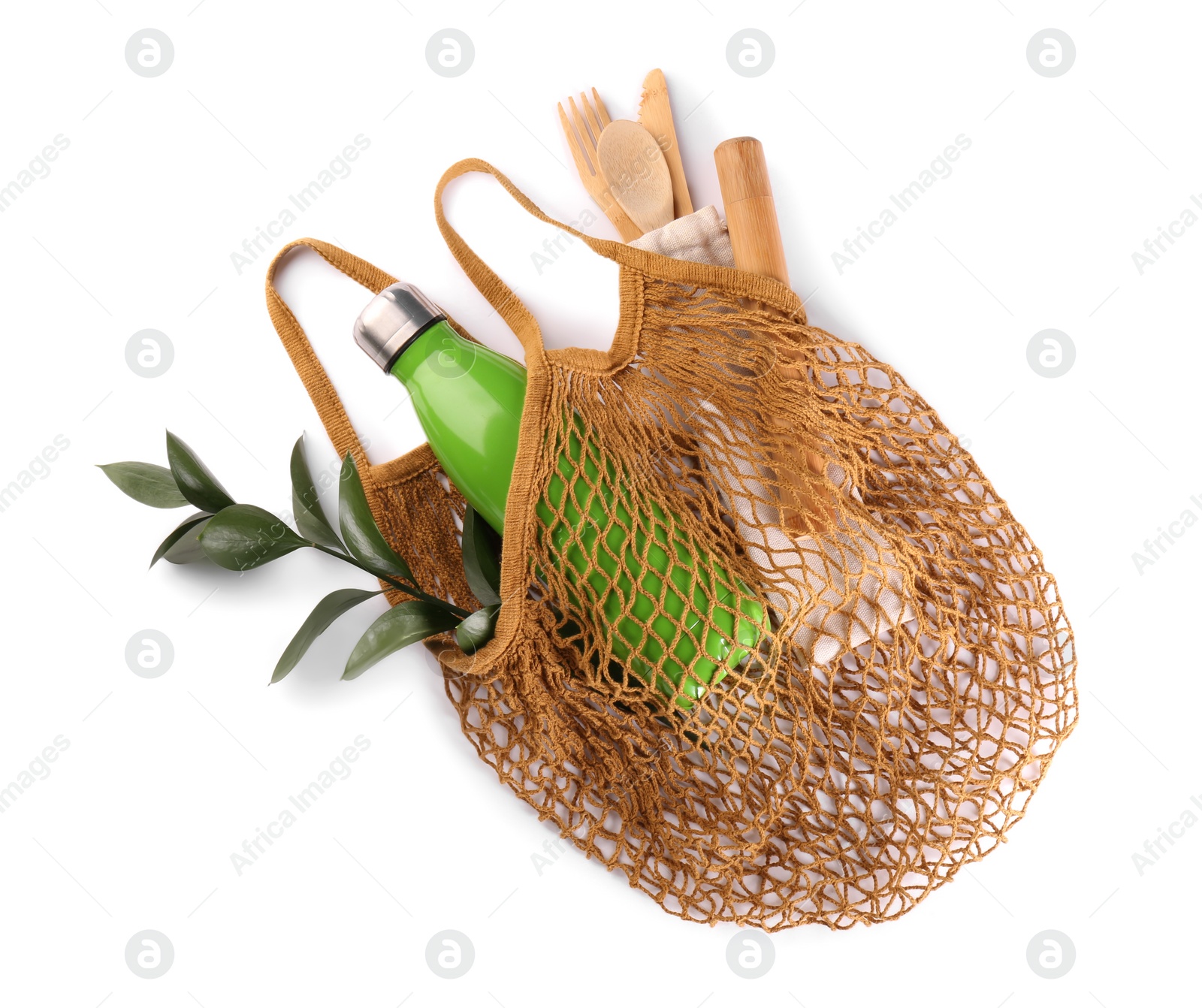 Photo of Fishnet bag with different items isolated on white, top view. Conscious consumption