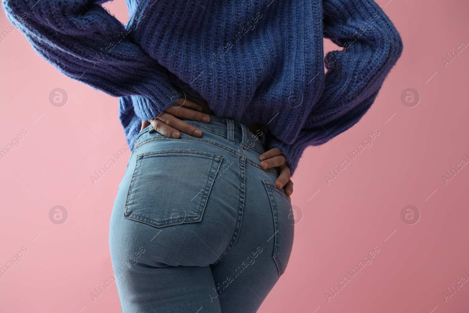 Photo of Woman wearing jeans on pink background, closeup