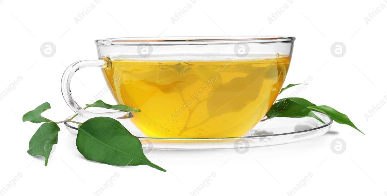 Photo of Fresh green tea in glass cup, leaves and saucer isolated on white