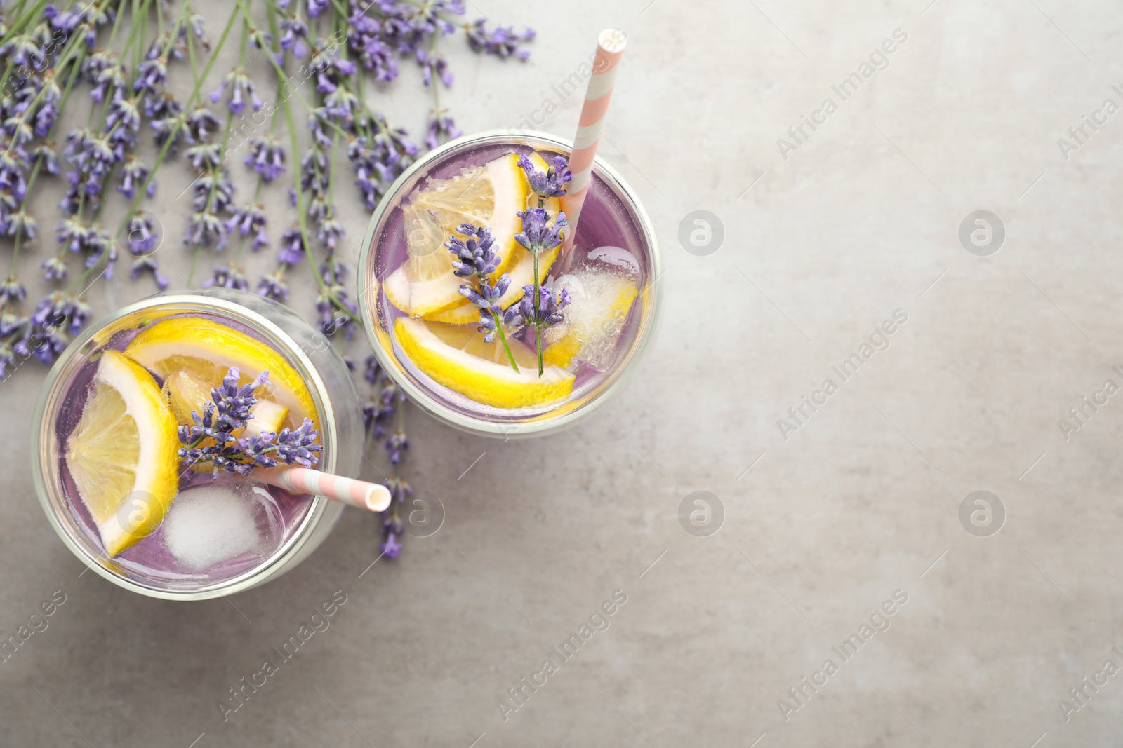 Photo of Fresh delicious lemonade with lavender on grey table, flat lay. Space for text