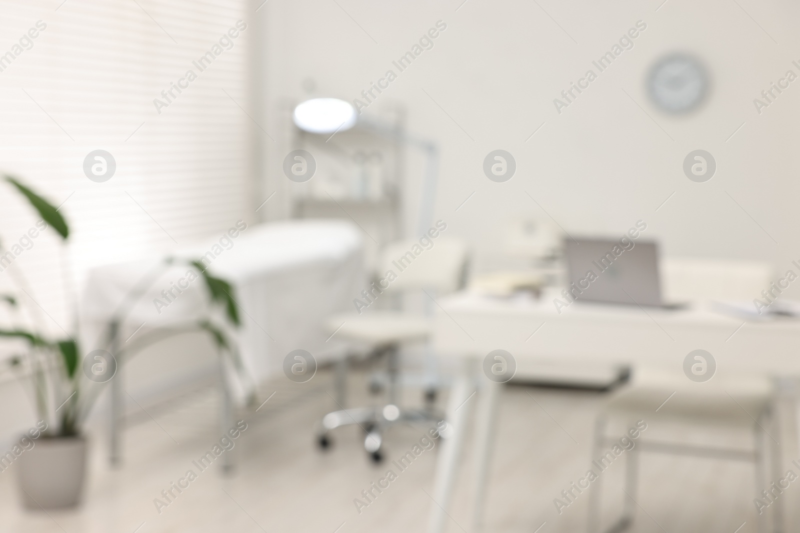 Photo of Blurred view of dermatologist's office with examination table