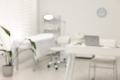 Photo of Blurred view of dermatologist's office with examination table