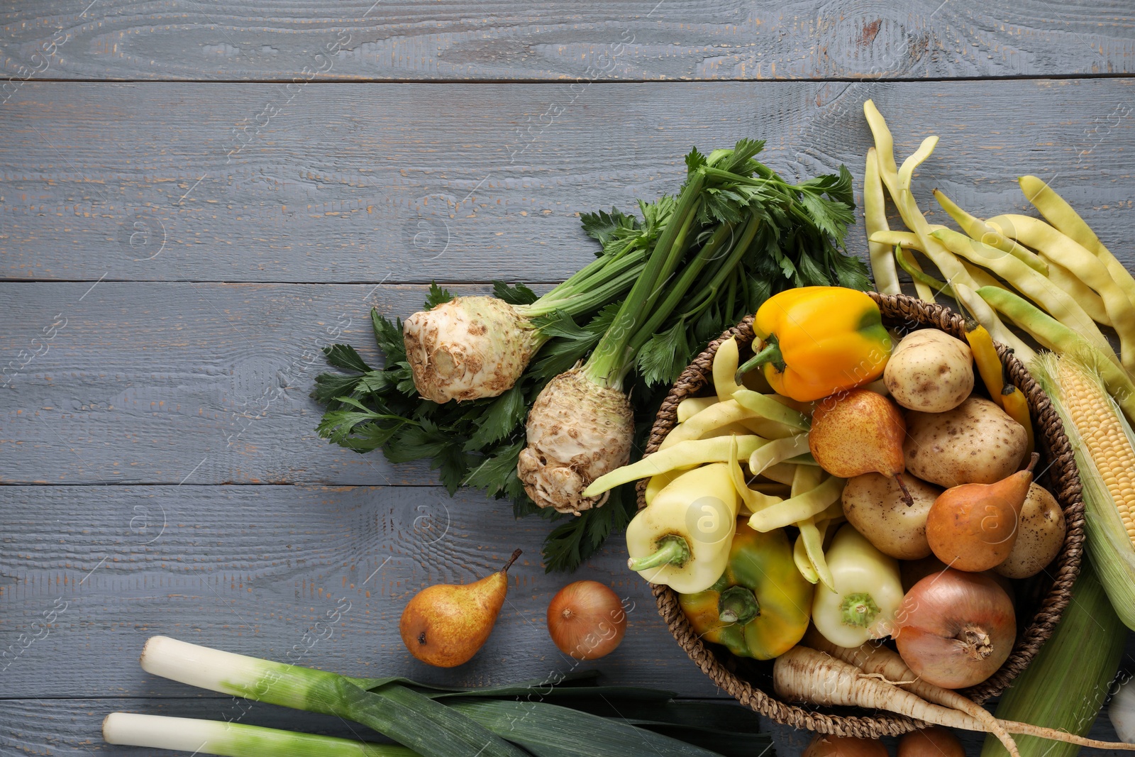 Photo of Different fresh ripe vegetables and fruits on grey wooden table, flat lay. Space for text