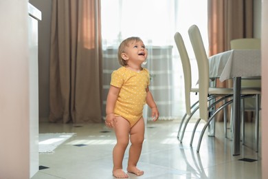 Photo of Cute baby learning to walk in room