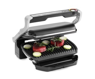 Electric grill with raw meat, zucchini and rosemary isolated on white