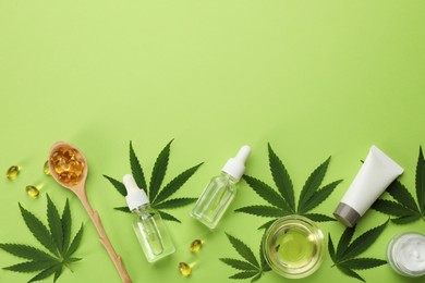 Photo of Flat lay composition with hemp leaves, CBD oil and THC tincture on green background, space for text