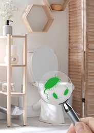 Woman with magnifying glass detecting microbes on toilet bowl in bathroom, closeup  