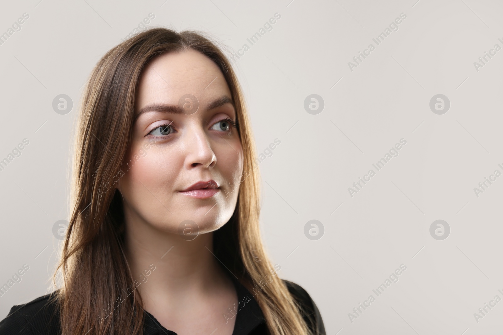 Photo of Portrait of beautiful young woman on beige background. Space for text