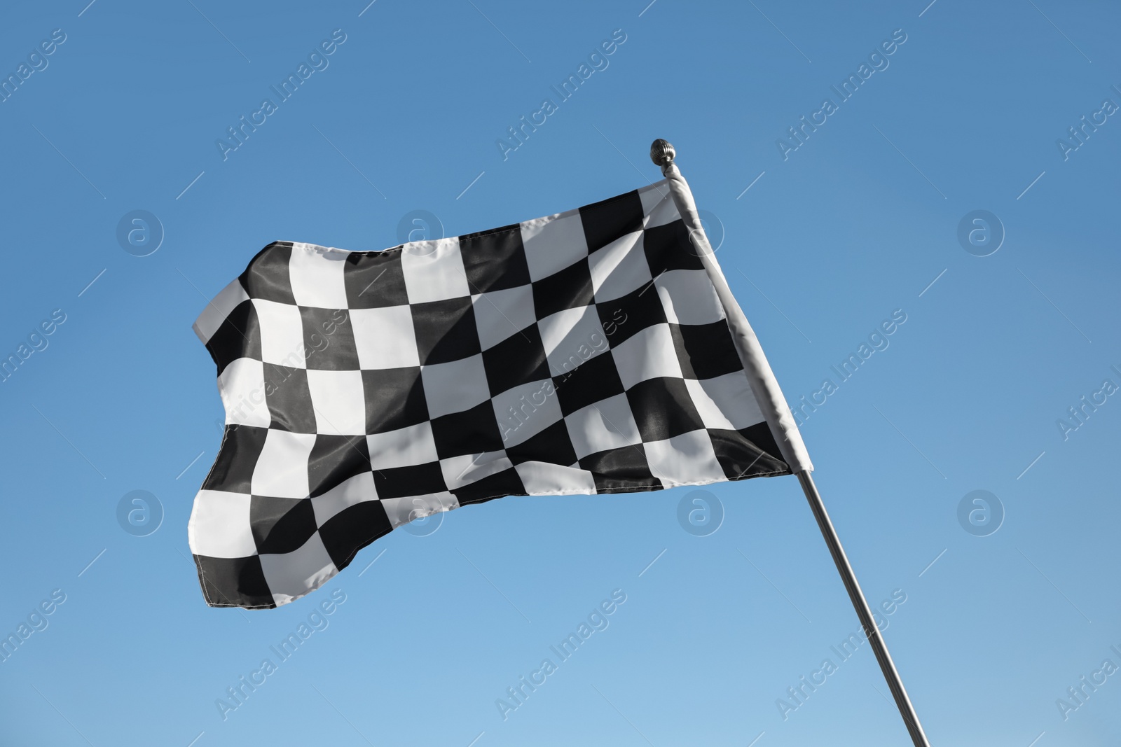 Photo of Checkered finish flag on light blue background