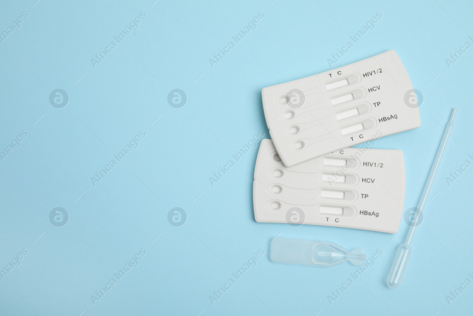 Photo of Disposable express hepatitis test kit on light blue background, flat lay. Space for text