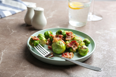 Delicious Brussels sprouts with bacon on marble table