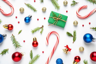 Flat lay composition with Christmas gift and festive decor on white background