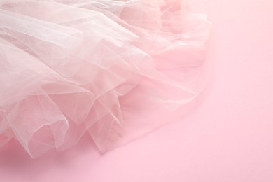 Photo of Beautiful white tulle fabric on pink background