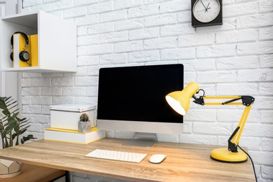 Comfortable workplace with computer on desk in home office