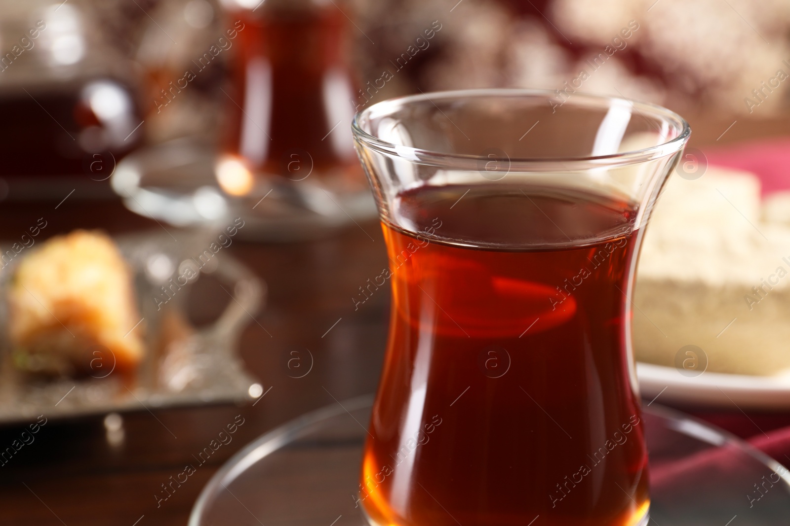 Photo of Traditional Turkish tea in glass on table, closeup. Space for text