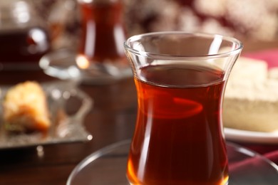 Photo of Traditional Turkish tea in glass on table, closeup. Space for text