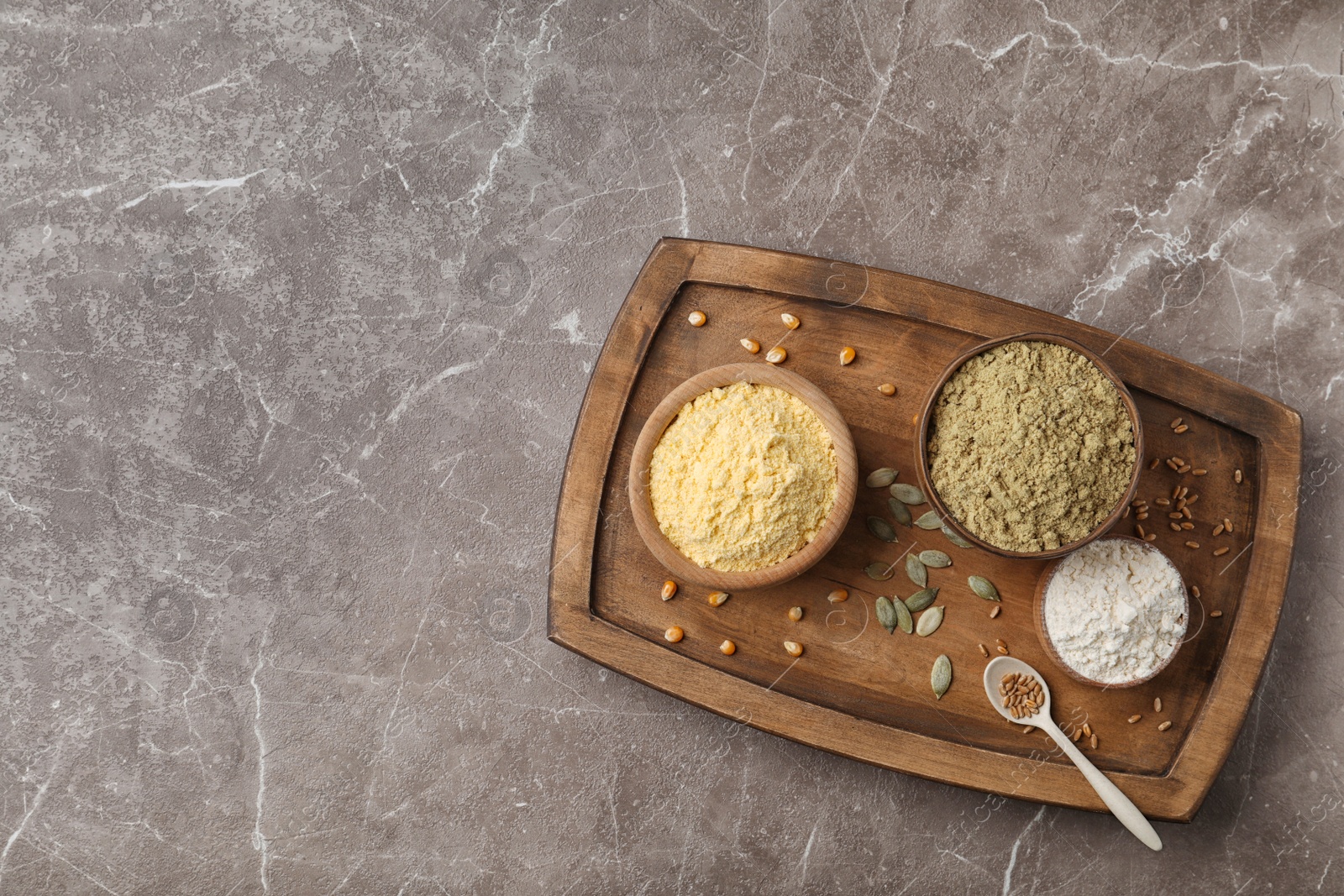 Photo of Composition with different types of flour on gray background