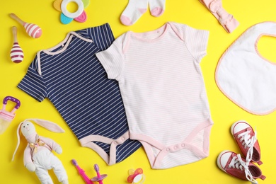 Flat lay composition with cute clothes on color background. Baby accessories