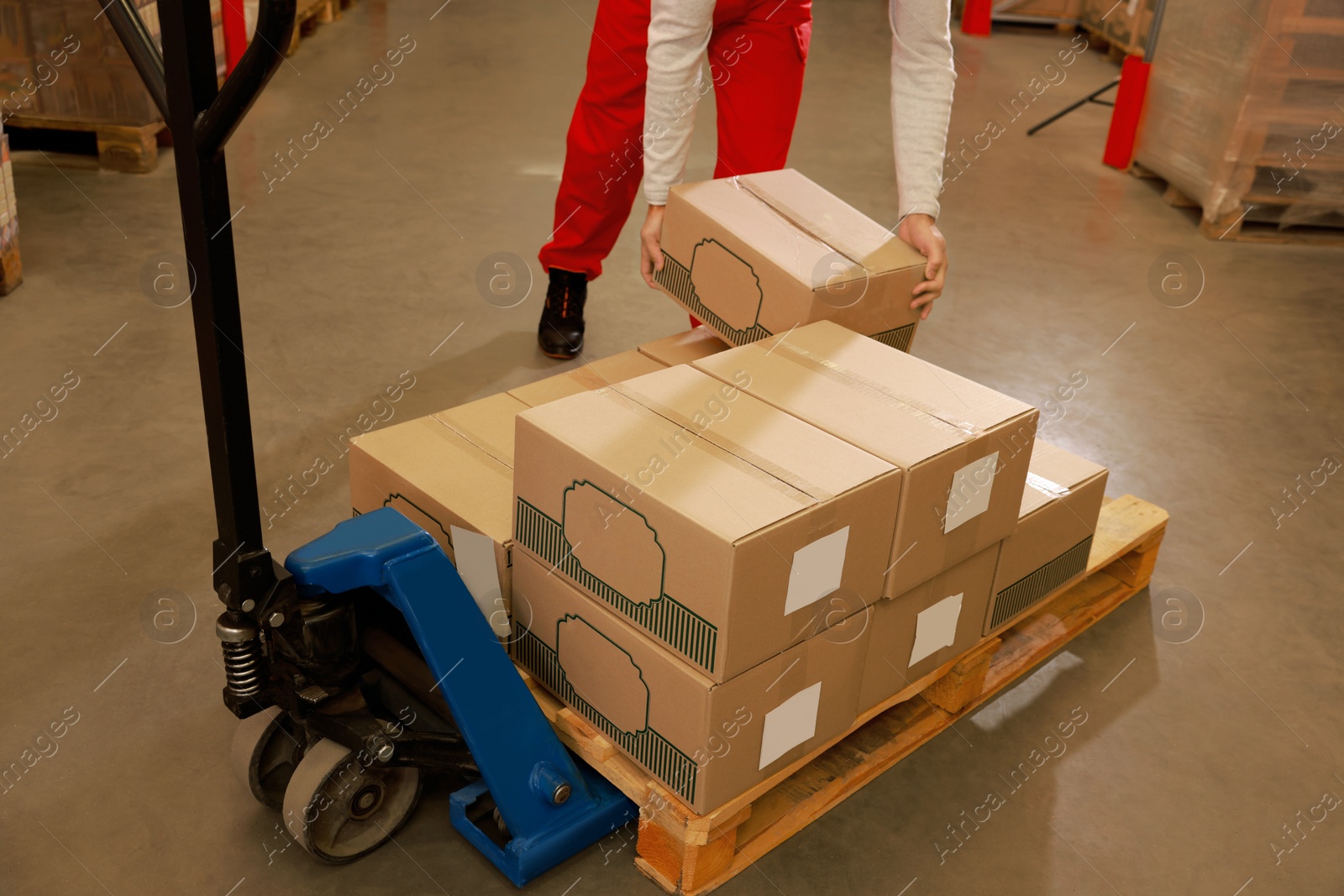 Image of Worker sorting cardboard boxes in warehouse, closeup. Logistics concept